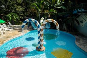 a swimming pool with a candy cane in the middle at Ecoresort Refúgio Cheiro de Mato in Mairiporã