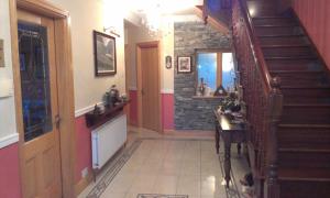 a hallway with a staircase in a house at DunnCourt House in Killarney