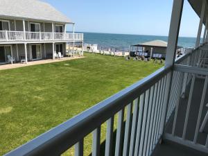 a view from the balcony of a house with a yard at The Three Seasons Resort in Dennis Port