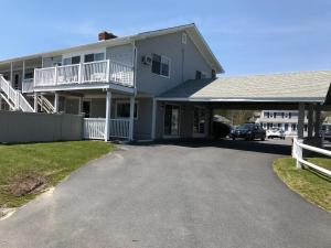 a house with a car parked in the driveway at The Three Seasons Resort in Dennis Port