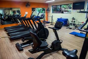 a gym with rows of exercise bikes and treadmills at Ecoresort Refúgio Cheiro de Mato in Mairiporã
