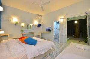 a bedroom with a large bed and a bathroom at SeaLaVie Inn in Ukulhas +143 photos