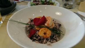 a white bowl of food with shrimp and rice at Apartma Ema in Izola