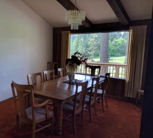 a dining room with a table and chairs and a large window at Wildwood Farm Bed & Breakfast in Oak Harbor