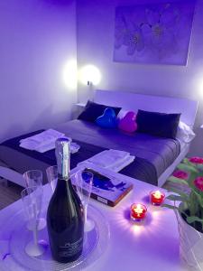 a living room with a bottle of wine on a table at Amedeo Square in Naples
