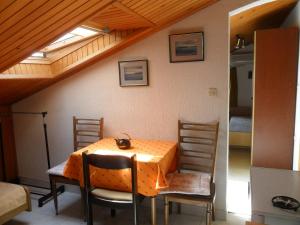 a dining room with a table and chairs and a ceiling at Apartments Simpa in Njivice