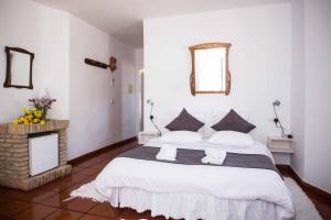 a bedroom with a large bed with two pillows at Cortijo de la Media Luna in Mojácar