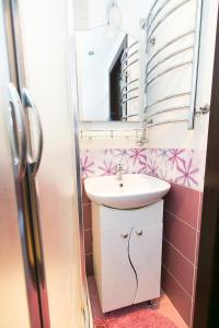 a bathroom with a sink and a mirror at VIP Apartment on Ilinska in Sumy