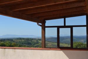 a view from the inside of a building with windows at Appartamento panoramico in Pancole