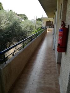 a hallway of a building with a red fire hydrant at Pericles Studios in Agia Marina Aegina