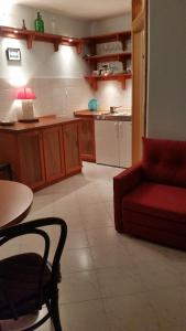 a living room with a red couch and a kitchen at Buena Vis-ta Apartments with the Sea View in Vis