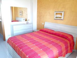 a bedroom with a bed with a plaid blanket at La Villetta di Andrè in Termoli