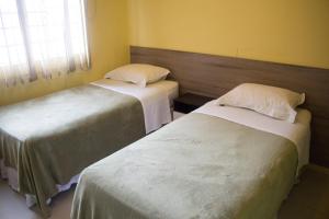 Postel nebo postele na pokoji v ubytování Hotel Dois Irmãos