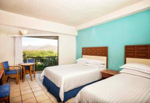Rúm í herbergi á Barceló Ixtapa - All Inclusive