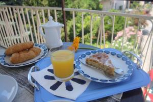 a blue table with a plate of food and a glass of orange juice at Da Fabio Bed and Breakfast in Agropoli