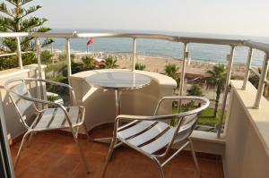 a balcony with a table and chairs and the ocean at Kleopatra Celine Hotel in Alanya