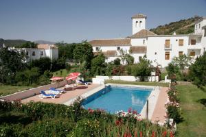 a resort with a swimming pool and a building at Hotel De Mecina Fondales in Mecina Fondales