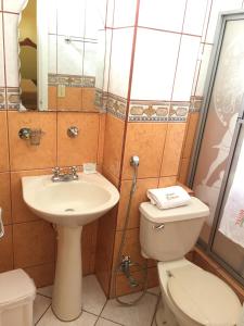 a bathroom with a toilet and a sink at Hotel Betania in Zamora
