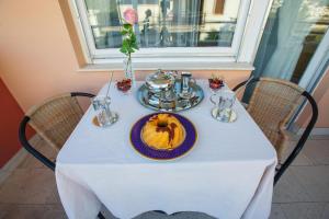 a table with a plate with a cake on it at Beach Rooms Split in Split