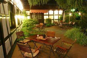 an outdoor patio with a wooden table and chairs at Hotel Vivendi in Herford