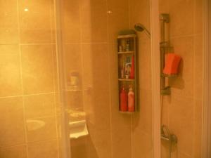 a bathroom with a shower with a glass shower stall at View Talay resort 5c condo 115A minimum stay 29 nights in Pattaya South +6 photos
