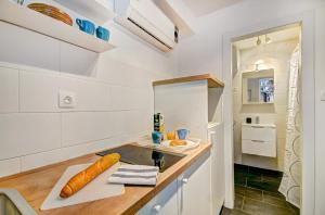 a kitchen with a sink and a counter top at Apartman Amfiteatar Franko in Pula +17 photos