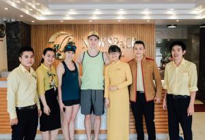 a group of people posing for a picture at New Space Hotel Airport in Ho Chi Minh City
