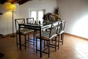a dining room with a glass table and chairs at L'Antica Pieve Bed & Breakfast in Levanto