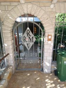 an archway with a gate with a run sign on it at Apartments villa MaVeRo in Banjole