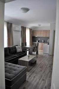 a living room with a couch and a table at Zevs Residence in Nesebar