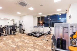 a gym with several treadmills and machines in a room at Hotel Gran Cerezo Kagoshima in Kagoshima