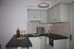 A kitchen or kitchenette at Philippos Kassiopi Apartments