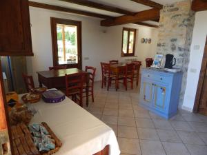 a kitchen and dining room with a table and chairs at I Lecci in Lerici