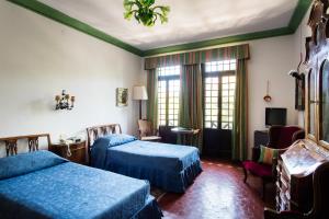 a hotel room with two beds and a tv at Residenza d'Epoca Albergo Quattro Fontane in Venice-Lido