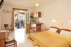A bed or beds in a room at Philippos Kassiopi Apartments