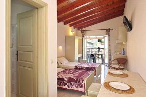 A bed or beds in a room at Philippos Kassiopi Apartments