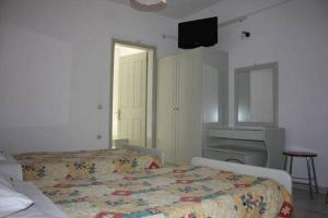 A bed or beds in a room at Philippos Kassiopi Apartments