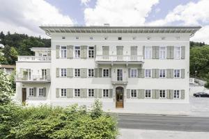 a large white building with a balcony at Palazzo Exclusiv Appartment in Tegernsee +11 photos