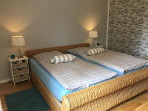 two beds sitting next to each other in a room at SEASIDE APARTMENTS - LIGHTHOUSE in Eckernförde