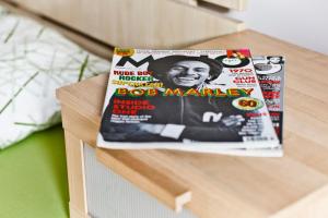 una revista sobre una mesa de madera en Apartment Grga, en Zagreb