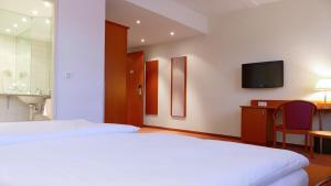 Voodi või voodid majutusasutuse Central Hotel Löwen toas