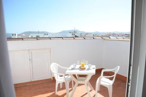 a white table and chairs on a balcony at Cotillo Ocean View in El Cotillo