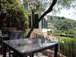 a table and chairs on the balcony of a house at Albergo Blueline in Tellaro