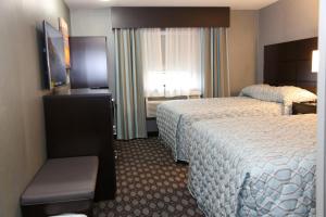 a hotel room with two beds and a window at Red Carpet Inn Elmwood in Elmwood Park