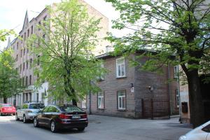 a car parked in front of a brick building at Varnu Apartment in Rīga