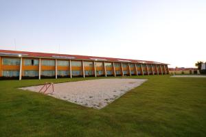 a building with a grass field in front of a building at Coroa Vermelha Beach - All Inclusive in Porto Seguro