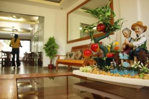 a table with a plant and figurines in a living room at Casa Belina in Puerto Princesa City