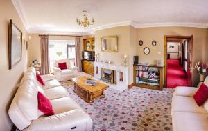 a living room with a white couch and a fireplace at The Harp in Killarney