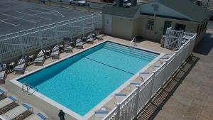 an overhead view of a large swimming pool with chairs at Casablanca Oceanside Inn in Ocean City