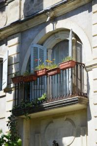 a balcony with potted plants on a building at Une Demeure d'Exception in Caveirac